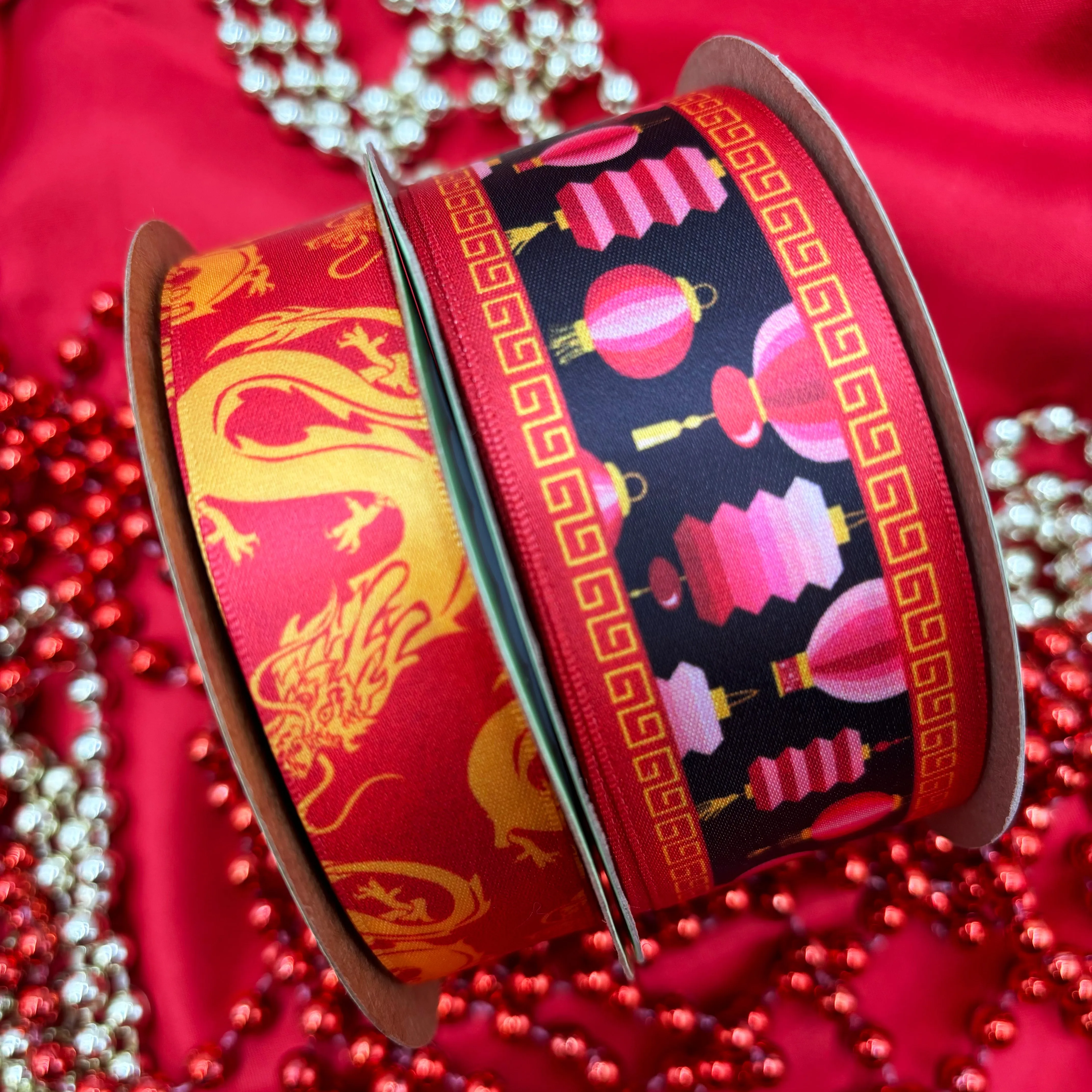 Chinese Lantern Ribbon Lunar New Year pink lanterns on a black background with a red greek key border printed on 1.5" white satin